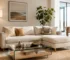 Bright, open-concept living room featuring small sectional sofas for small spaces (ركنات للمساحات الصغيرة) in an off-white fabric. The compact L-shaped couch is accented with textured neutral pillows, paired with a glass coffee table, a wooden tripod floor lamp, and a natural jute area rug